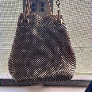 This is a gold beautiful bag and the strap can be taken off and clips together